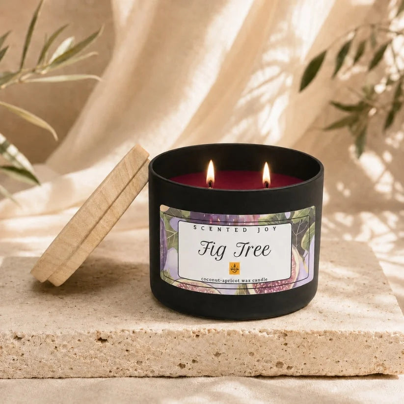 Scented Joy Fig Tree coconut-apricot wax candle lit in a matte black jar.