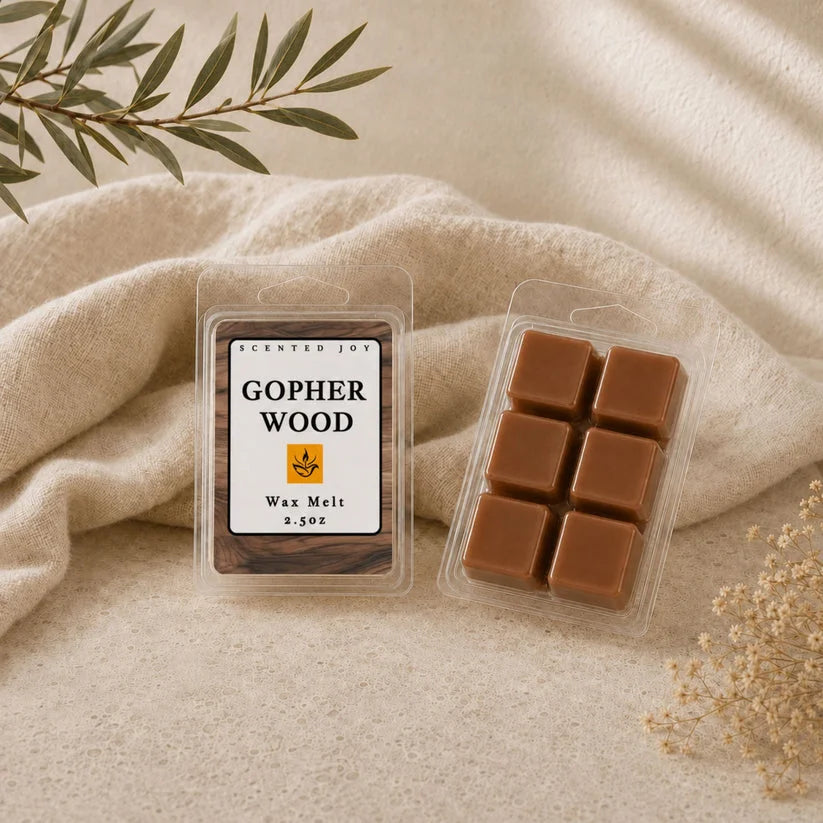 Gopher Wood scented wax melts by Scented Joy on a linen cloth with olive branch