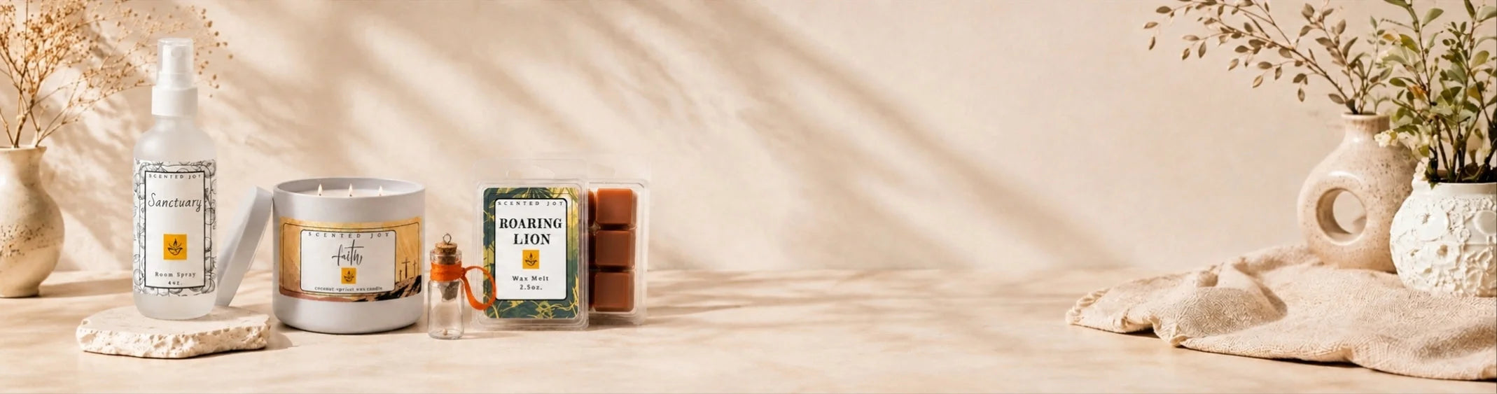 Scented Joy home fragrance products: Sanctuary spray, Faith candle, and Roaring Lion wax melts.